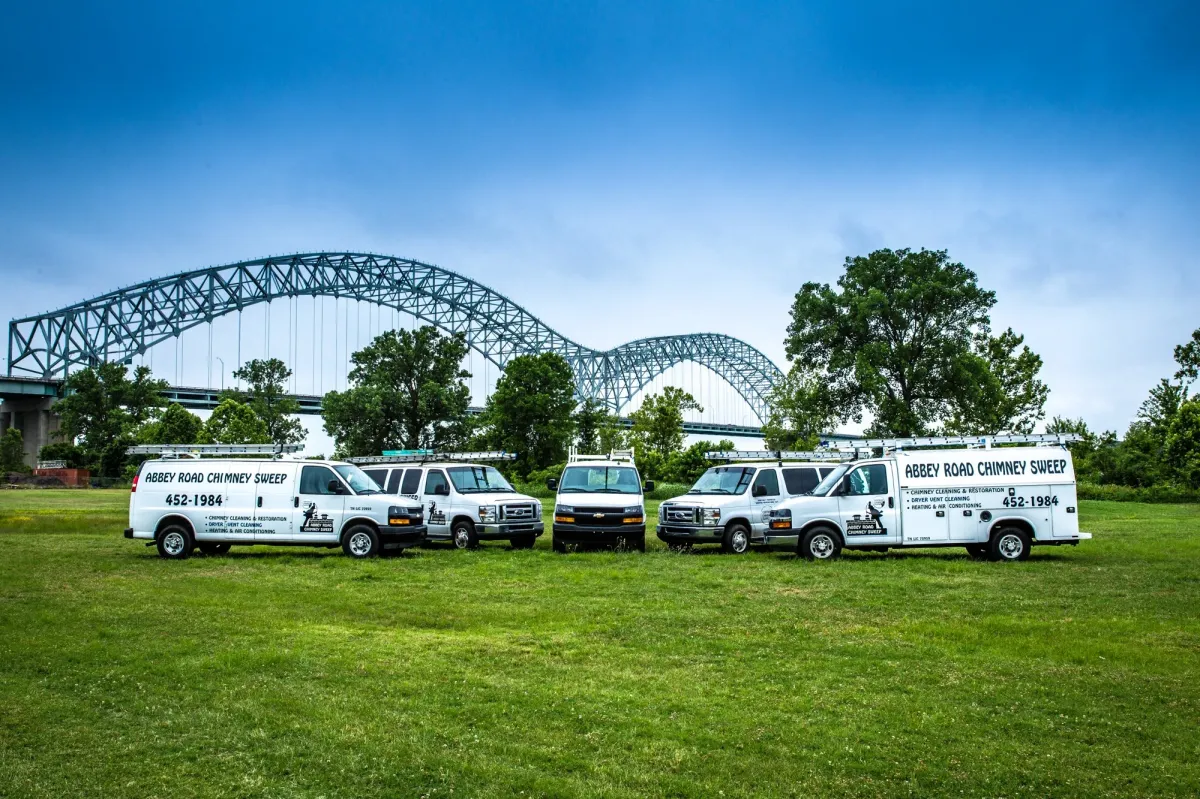 The Abbey Road Chimney Sweep fleet of service vans lined up by the Memphis bridge